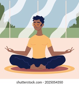 young man doing meditation indoors