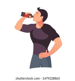 Young man drinking soda. Enjoy cool drink concept. Red plastic bottle holding in mans hand