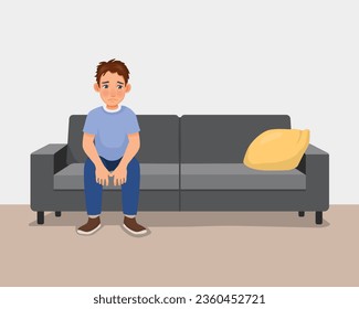 Young man feeling sad and lonely sitting on couch at home