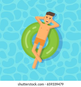 Young man floating on an inflatable circle in a swimming pool