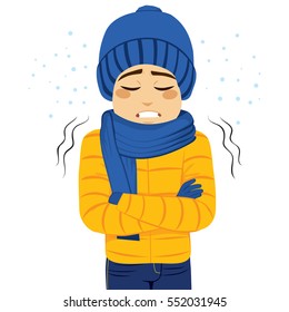 Young man freezing wearing winter clothes shivering