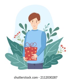 Young man gift concept in flat style. A happy guy standing and holding a gift in his hands. Natural background of green leaves. Cute vector illustration.