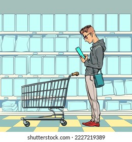 A young man with a grocery cart in the store looks at the phone. Online product selection. Electronic commerce. Pop art retro vector illustration kitsch vintage 50s 60s style