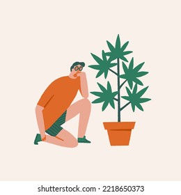 Young Man growing marijuana in the pot at home. Cannabis and weed legalization concept. 