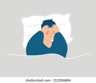 Young man had insomnia and headaches. Boy suffers from migraine has difficulty of falling asleep during night. Male looks sleepy and touches his head. Trouble sleeping, anxiety, mental health disorder