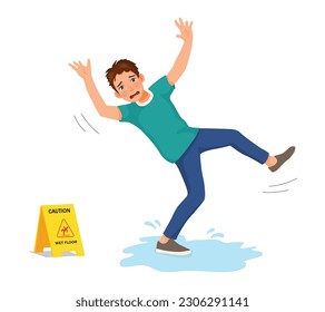 Young man having accident slipping on wet floor and falling down near yellow caution sign