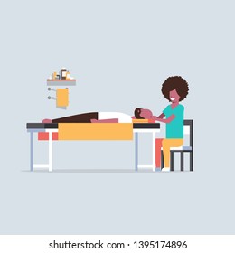 young man having head massage african american masseuse massaging patient body guy relaxing lying on table luxury spa salon treatments concept full length