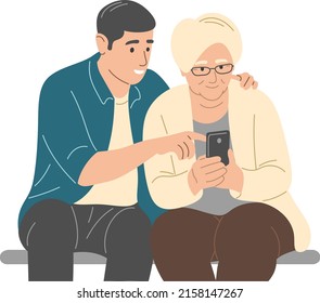 A young man helps his grandmother with the phone.