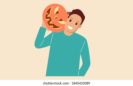 Young man hold halloween pumpkin head