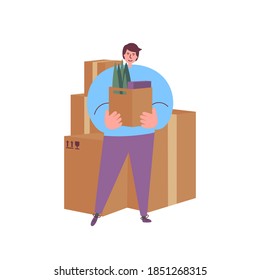 Young man holding a cardboard box with his stuff ready to move to a new place. Person relocating. Moving boxes. Home moving concept. A set of packed boxes. 