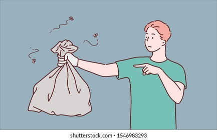 Young man holding a garbage bag and pointing isolated on gray background. Hand drawn style vector design illustrations.