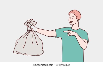 Young Man Holding A Garbage Bag And Pointing Isolated On White Background. Hand Drawn Style Vector Design Illustrations.