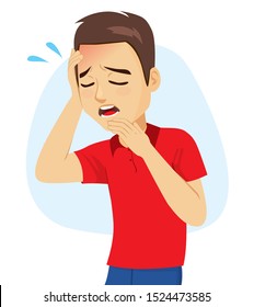 Young man with holding head with hand suffering headache fatigue migraine symptom