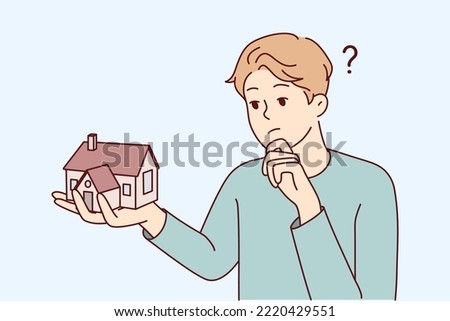 Young man holding house thinking of mortgage or loan. Confused male with home maquette frustrated with housing rent or purchase. Real estate agent. Vector illustration. 