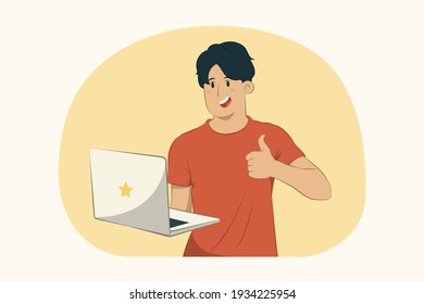 Young man holding laptop pc computer, showing thumb up concept