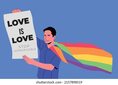 Young man holding lgbt banner at a gay pride parade - Love is love - Stop homophobia