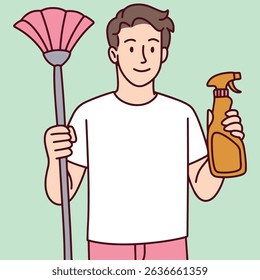 Young man holding a mop and cleaning spray, smiling, standing on a mint green background, representing cleanliness, sanitation work, or household chores