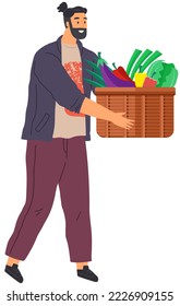 Young man holding package with purchases fresh vegetables. Smiling man with carrot veggie, portrait. Shopping in grocery store, food delivery to your home and restaurant. Fresh organic products