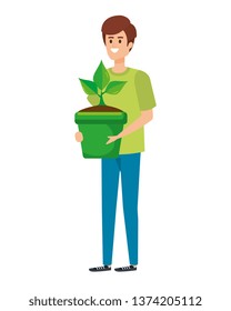 young man lifting houseplant in pot