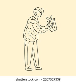 A young man looks in front of him and holds a box in his hands. Vector linear illustration drawn by hand.