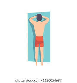 Young man lying on his stomach and sunbathing on the beach, top view of lying guy vector Illustration on a white background