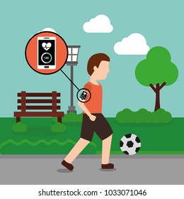 young man with mobile app playing soccer ball in the park