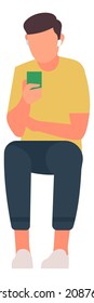 Young man with mobile phone. Sitting guy holding smarthone