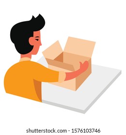 Young man opening, unpacking a box on a desktop.
