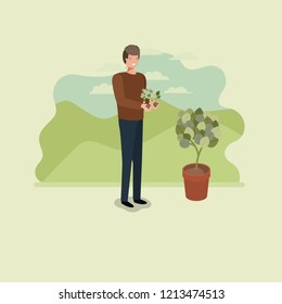 young man planting tree in the park