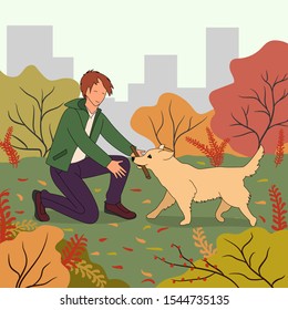 Young man playing with the dog. Training golden retriever. Training pet. Autumn cityscape.