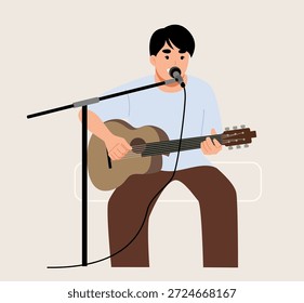 Un joven tocando la guitarra.