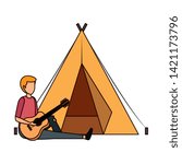young man playing guitar with camping tent