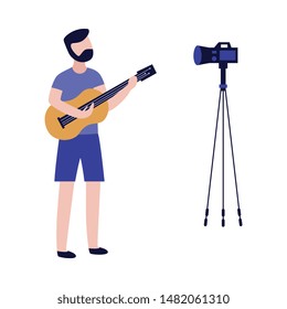 Young man playing guitar and recording video with camera in flat style isolated on white background - vector illustration of male musician blogger creating content for his musical vlog or channel.