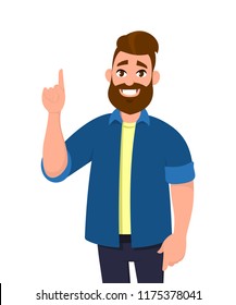 Young Man pointing up finger while standing and smiling. Man pointing copy space. Emotion and body language concept in cartoon style vector illustration.