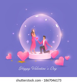 Young Man Proposing His Girlfriend Inside Glass Globe With Glossy Pink Hearts On The Occasion Of Happy Valentine's Day.