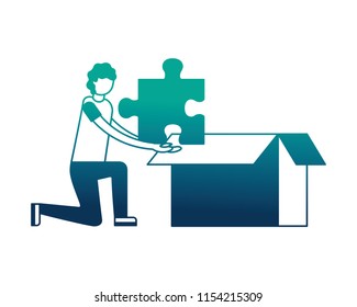 young man with puzzle piece and box carton