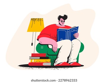 A young man is reading a book. A student is sitting in an armchair with a book. Library, bookstore