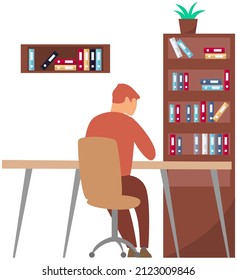 Young man reading books at home or working with document in office sitting at table back view. Self-education and studying concept. Guy looking at book with pages. Reading literature using textbook