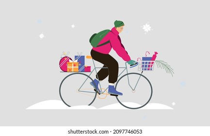 Young man rides a bicycle under snow fall in warm clothing with gift boxes for christmas. Flat vector illustration