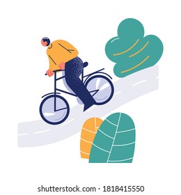Young man riding bicycle downhill in green city