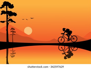 young man riding bicycle on sunset backgrounds