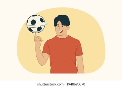 Young man rotating soccer ball on finger concept
