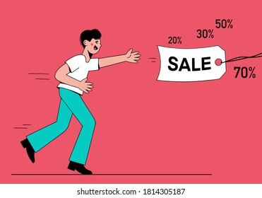 Young man runs for a label that says Sale. Day of big discounts.