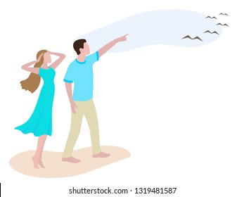 Young man showing to girl birds in the sky. Romantic couple walking on the beach. Man and woman on the walk looking up in sky. Boy and girl in casual clothes: teal female dress, cyan male t-shirt 