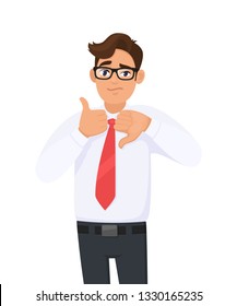 Young man showing/gesturing/making thumbs up and thumbs down sign/symbol. Man in formal dress and red colour tie. Business man making good-bad, like-dislike sign. Undecided person between yes or no. 