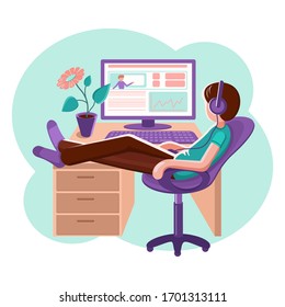 A young man sits at a computer.