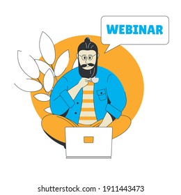 A young man sits with a cup of coffee in front of a laptop and watches a webinar. Video online conference.
