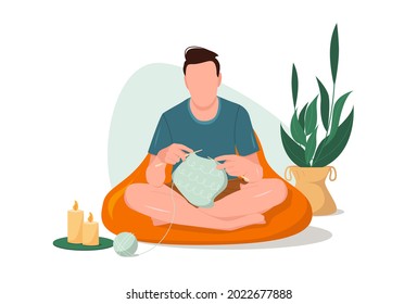 Ein junger Mann sitzt und mit Knitting Needles stricken warme Kleidung. Genießen Sie ein Hobby in einer gemütlichen Umgebung. Vektorgrafik im Flachstil.
