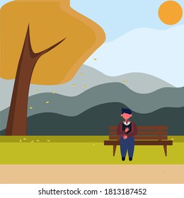 A young man sits on a bench in the Park and reads a book, a Man in an autumn Park