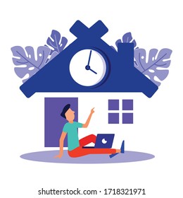 The young man sits on the floor with a laptop and works online at an illustrated house. Social distance and self-isolation during the corona virus quarantine.